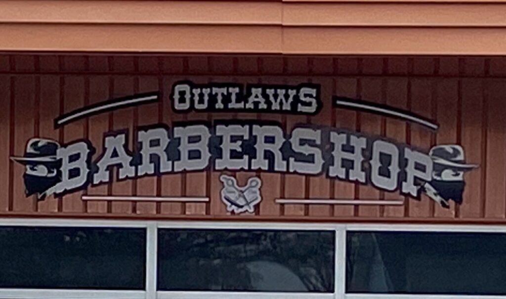 Outlaws Barbershop cabinet sign